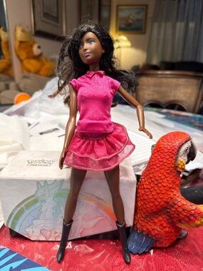 Mattel Barbie doll with dark skin, long brown hair, and brown eyes, wearing a